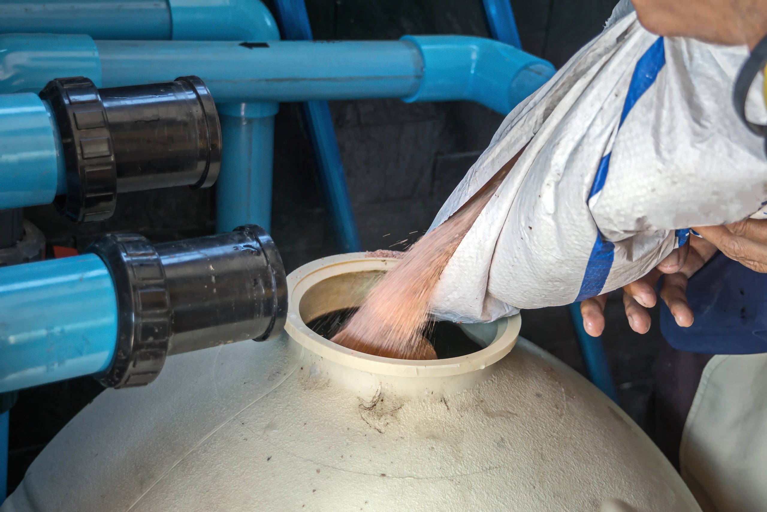 Filling sand into sand filter.Service and maintenance of the pool.