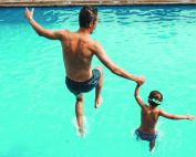 Father and son having fun on the pool
