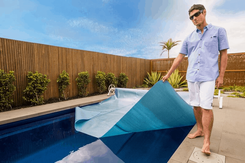 Lifestyle photo of the Daisy UltraDome Pool Cover. Available at Swimart.